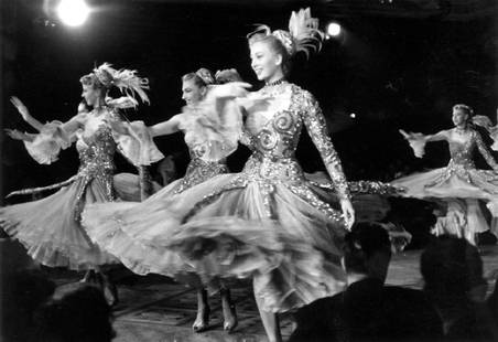 Bluebell Girls: Artist: Bert Hardy Title: Bluebell Girls Medium: Silver Gelatin Year: 1955 Height/Width: 16 x 20 in Description: 1955: The famous Bluebell Girls of Paris. Original Publication: Picture Post – 7873