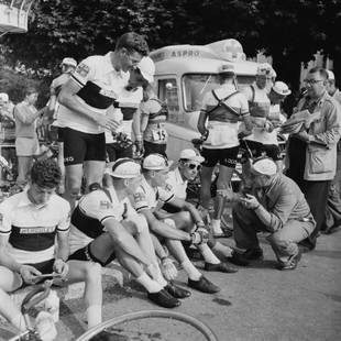 British Cycling Team: Artist: Bert Hardy Title: British Cycling Team Medium: Silver Gelatin Year: 1955 Height/Width: 16 x 16 in Description: British cycling team manager Syd Cozens (crouching, right) encouraging his team d