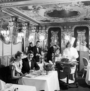 Eating At The Royal: Artist: Bert Hardy Title: Eating At The Royal Medium: Silver Gelatin Year: 1953 Height/Width: 12 x 12 in Description: A couple eating in the Cafe Royal in Piccadilly, London.1953 A beautiful Limited