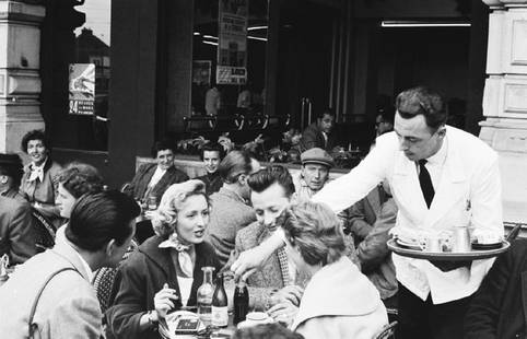 Encore Du Vin: Artist: Bert Hardy Title: Encore Du Vin Medium: Silver Gelatin Year: 1955 Height/Width: 20 x 30 in Description: A waiter serving clients outside a cafe in Le Mans, France, July 1955. Original publicat