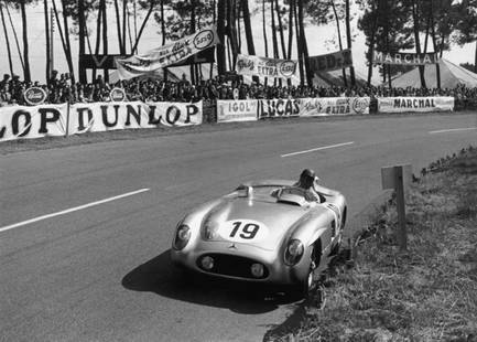 Fangio At Le Mans: Artist: Bert Hardy Title: Fangio At Le Mans Medium: Silver Gelatin Year: 1955 Height/Width: 12 x 16 in Description: Argentinian racing driver Juan Manuel Fangio (1911 – 1995) in a Mercedes-Benz