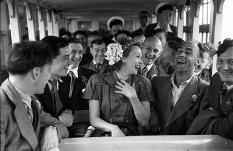 Ferry Passengers: Artist: Bert Hardy Title: Ferry Passengers Medium: Silver Gelatin Year: 1947 Height/Width: 16 x 20 in Description: French film actress Mila Parely amuses passengers onboard the ferry from Tower