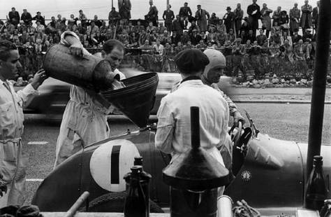 Fill Her Up: Artist: Bert Hardy Title: Fill Her Up Medium: Silver Gelatin Year: 1947 Height/Width: 20 x 20 in Description: Pit staff filling up Louis Chiron’s (1899 – 1979) Maserati. Original Publication: Pict