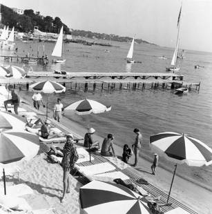 French Riviera: Artist: Bert Hardy Title: French Riviera Medium: Silver Gelatin Year: 1955 Height/Width: 16 x 16 in Description: A beach on the French Riviera or Cote d’Azur, where the wealthy come to sunbathe