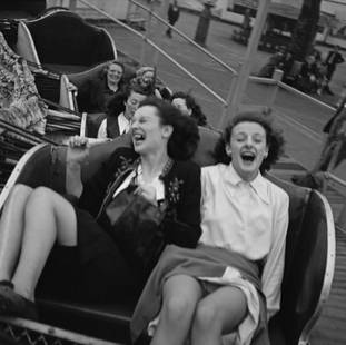 Fun In Southend: Artist: Bert Hardy Title: Fun In Southend Medium: Silver Gelatin Year: 1952 Height/Width: 20 x 20 in Description: A group of women enjoy one of the rides at the Kursaal amusement park during a day