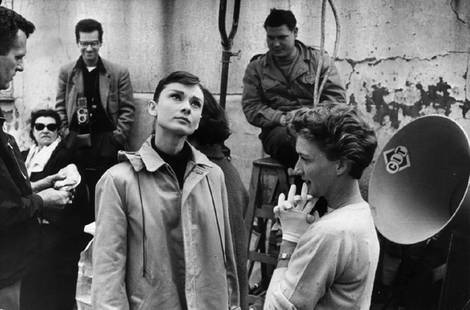 Funny Face: Artist: Bert Hardy Title: Funny Face Medium: Silver Gelatin Year: 1956 Height/Width: 16 x 20 in Description: On the left, film star Audrey Hepburn (1929 – 1993) with the crew of the Paramount film