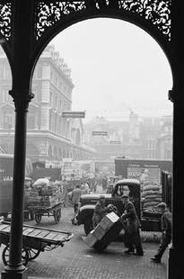 Garden Arch: Artist: Bert Hardy Title: Garden Arch Medium: Silver Gelatin Year: 1950 Height/Width: 16 x 12 in Description: Porters at work at Covent Garden Market, London, March 1950. Original publication: Picture