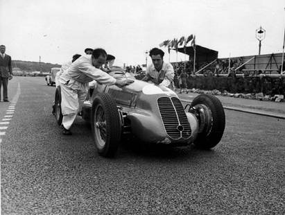 Man Power: Artist: Bert Hardy Title: Man Power Medium: Silver Gelatin Year: 1947 Height/Width: 12 x 16 in Description: Mechanics giving Louis Chiron’s Maserati a push. Original Publication: Picture Post – 43