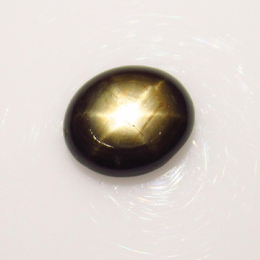 4.85 Ctw Natural Six Line Black Star Sapphire Oval Cab: No Reserve! Title: 4.85 Ctw Natural Six Line Black Star Sapphire Oval Cab Stone Clarity: Transparent Loose Gemstone: Black Star Sapphire Size/Dimensions: 11.30 x 9.70 x 4.00 mm Carat Weights: 4.85 Top