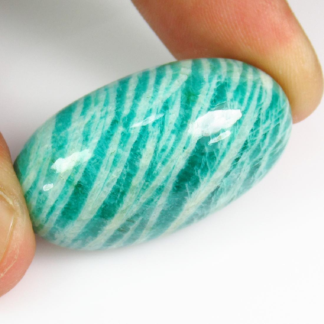 49.52 Ct Genuine Green Zebra Apatite 33X18.5 mm Oval: No Reserve! Title: 49.52 Ct Genuine Green Zebra Apatite 33X18.5 mm Oval Cab Stone Clarity: VVS Loose Gemstone: Natural Zebra Apatite Carat Weights: 49.52 Size / Dimensions: 33.00 x 18.40 x 11.50 mm Bi
