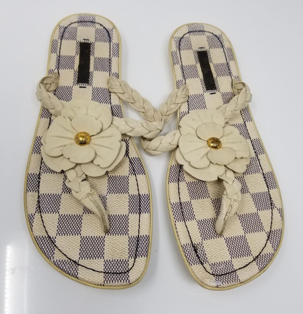 Louis Vuitton Sandals Flip Flops Damier Azur Made in: We offer this pair of Louis Vuitton damier azur flat heel sandals with flower detail. This pair of flip flops from Louis Vuitton are just in time for summer. The LV sandals are crafted in the damier a
