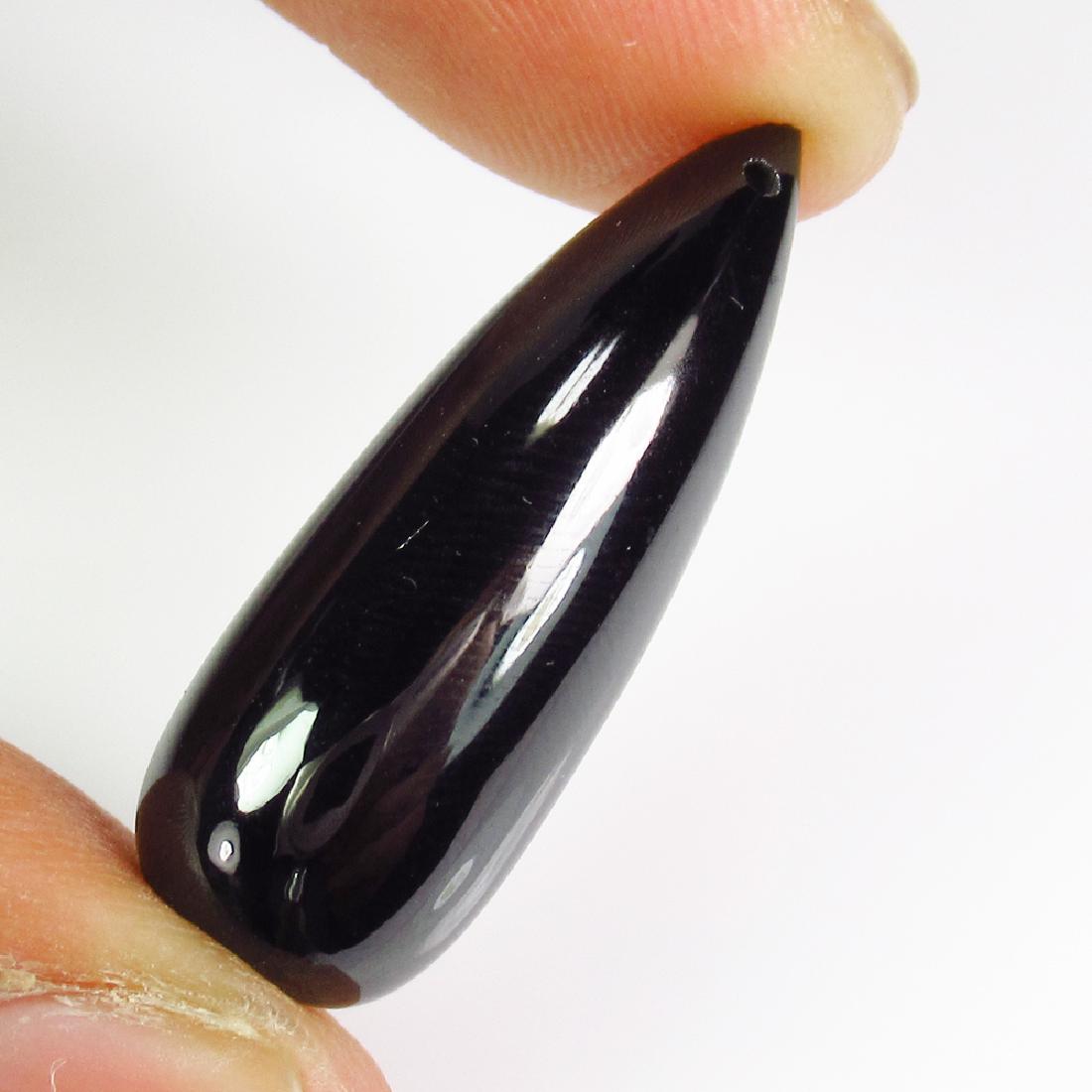 30.90 Ct Genuine Black Spinel 30X10 mm Drilled Pear: No Reserve! Title: 30.90 Ct Genuine Black Spinel 30X10 mm Drilled Pear Drop Stone Clarity: Opaque Gemstones: Natural Spinel Carat Weights: 30.90 Size/Dimensions: 30.00 x 10.20 x 10.20 mm Additional In