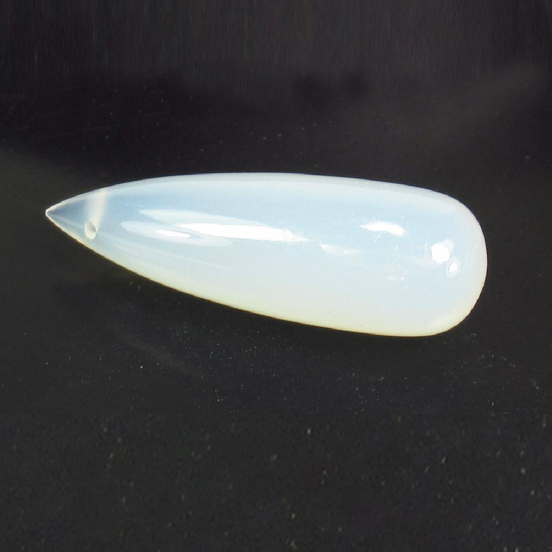 21.55 Ct Genuine Chalcedony 30X10.5 mm Drilled Pear: No Reserve! Title: 21.55 Ct Genuine Chalcedony 30X10.5 mm Drilled Pear Drop Stone Clarity: Transparent Gemstones: Natural Chalcedony Carat Weights: 21.55 Size/Dimensions: 30.10 x 10.40 x 10.40 mm Addi