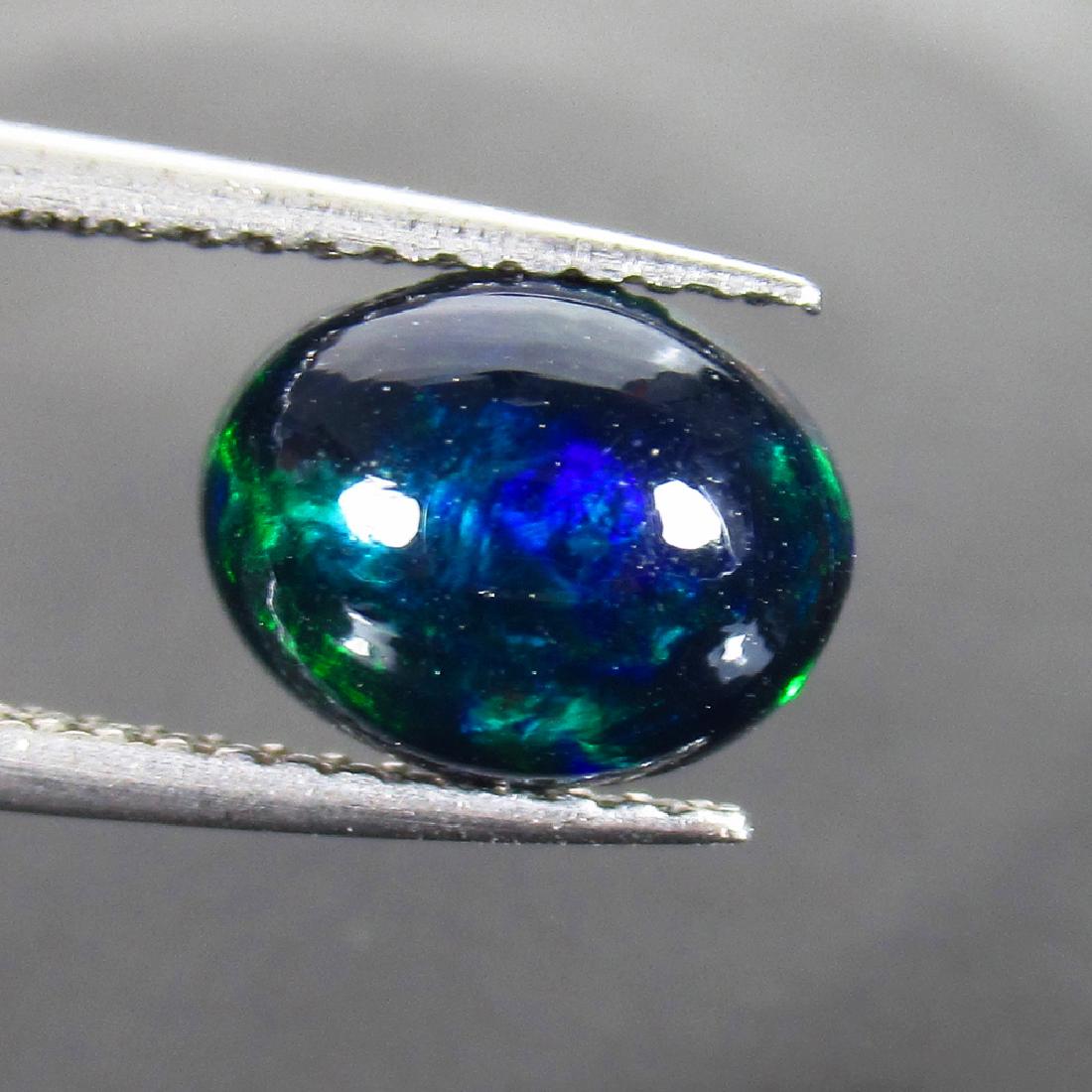1.38 Ct Natural Ethiopian Black Opal 9X7 mm Oval Cab (1 of 2)
