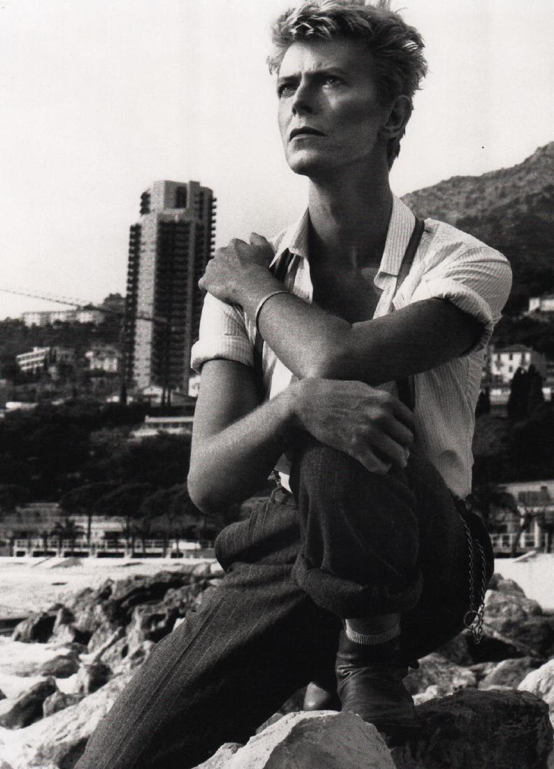 HELMUT NEWTON - David Bowie on the beach in Monte Carlo: Artist: HELMUT NEWTON Print Title: David Bowie on the beach in Monte Carlo Medium: Photo-lithograph Printed in 2000’s in Italy Image size (inches) approx. 10 x 7” Helmut Newton (1920-2004) was a G