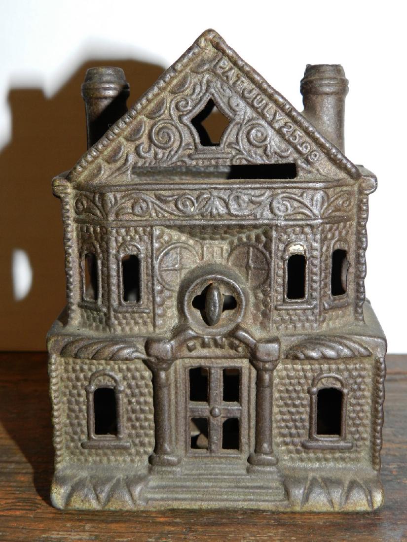 Cast Iron Still Bank: Title: Cast Iron Still Bank Dimensions: Measures 4-1/4” Tall To the Peak, 3-1/4” Wide and 2-1/2” Deep. Provenance/Additional Information: Cast Iron Two Piece Architectural Still Bank depicting a