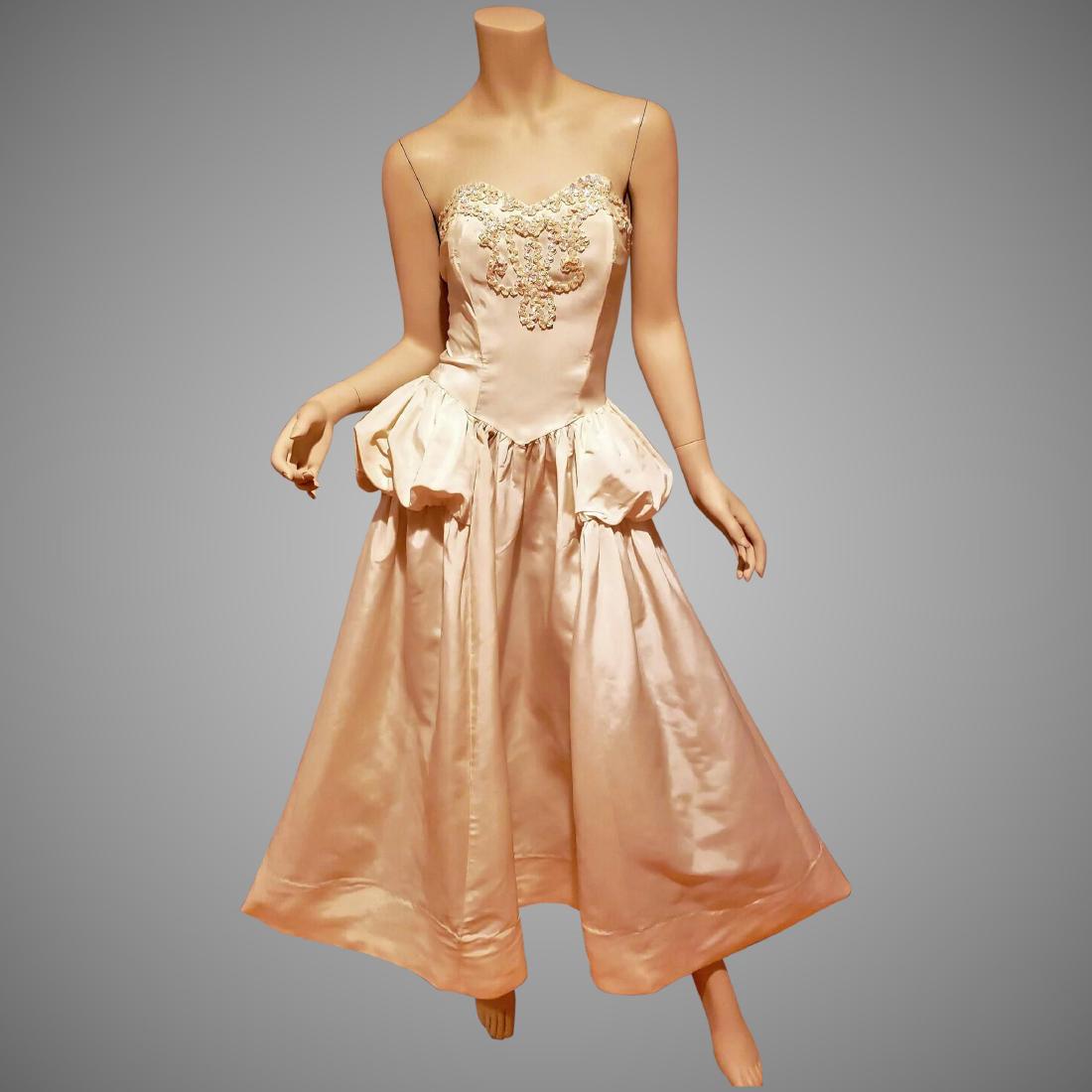 Vtg 1950 strapless ball gown with basque and bodice: A stunner. 1950's silk shantung strapless bustier boned ball gown with basque to each side. The front bodice is embellished with mother of pearl sequins in a beautiful design..The skirt is fluid and f