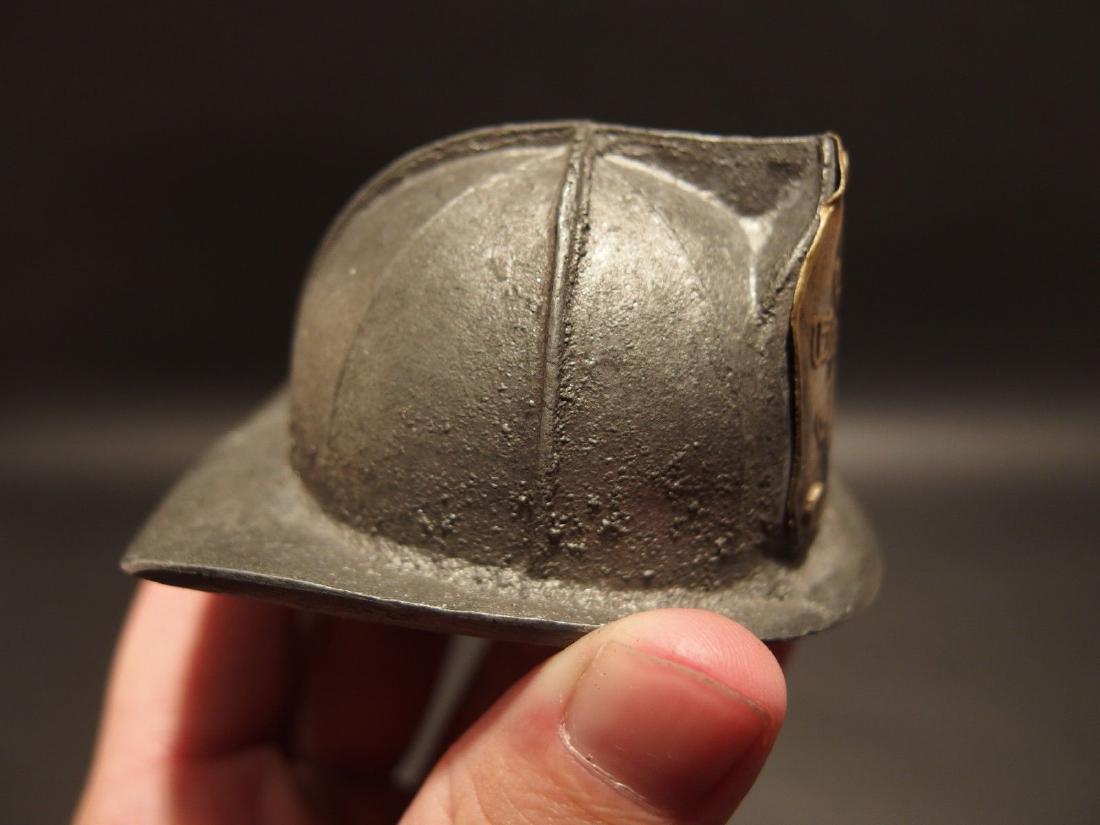 Miniature Fireman Fire Helmet Fighter Bottle Cap Opener: 3 1/8" Long x 2 5/8" wide x 1 1/2" Tall Such a neat reproduction fire helmet bottle cap opener! This piece seems to be cast aluminum with a brass plaque. Nice heavy quality with nicks and chips all ov