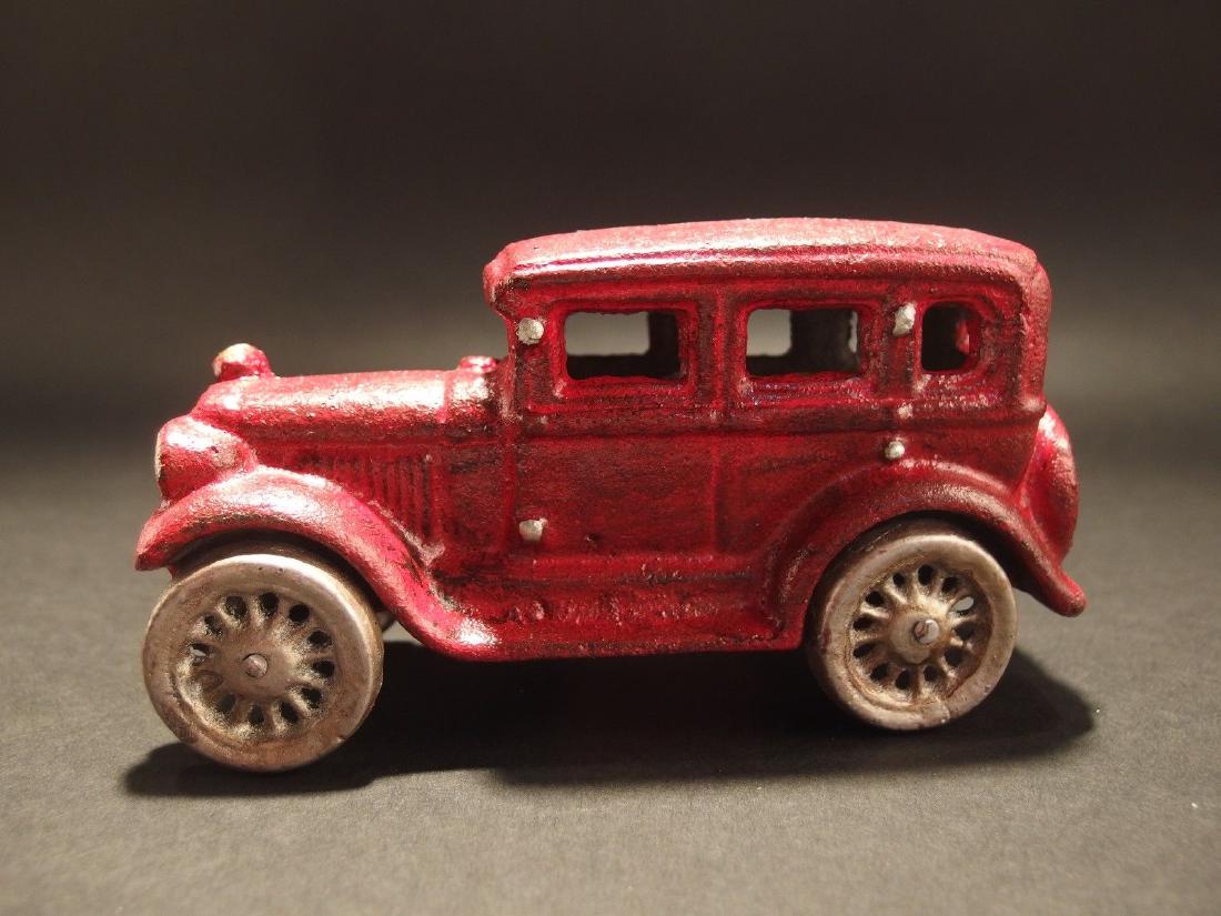 Cast Iron Red Sedan Toy Car: 6" Long x 2" Wide 3 1/8" Tall 2 lbs Such a neat reproduction cast iron car! As you can see this heavy cast iron car was wonderfully hand painted and distressed to look original. The car is mostly red