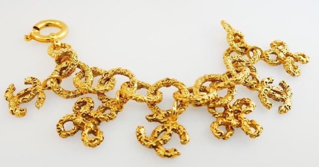 CHANEL GOLD VERMEIL NUGGET STYLE 6 CHARMS BRACELET: NS GT0 Pretty and elegant, it's a classic nugget style bracelet with a spring ring clasp created by Chanel in France.Made of vermeil gold.Measurements: Lengths 9", each charm is about 1/2 inch. Weight