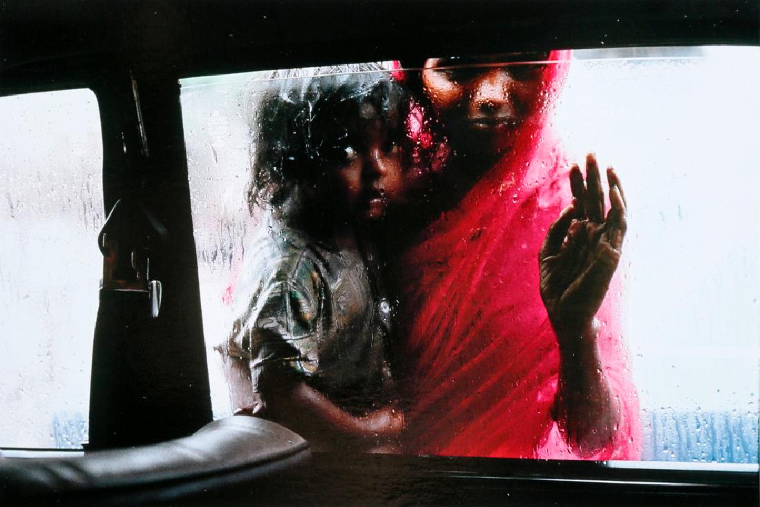 STEVE MCCURRY - Mother and child at Car window,: Artist: Steve McCurry Title: Mother and child at Car window, Bombay, India, 1993 Date Printed: 2008 Medium: Photo Litho with Copyright Steve McCurry/Magnum Photos Printer Location: Italy Size: 15x22 c