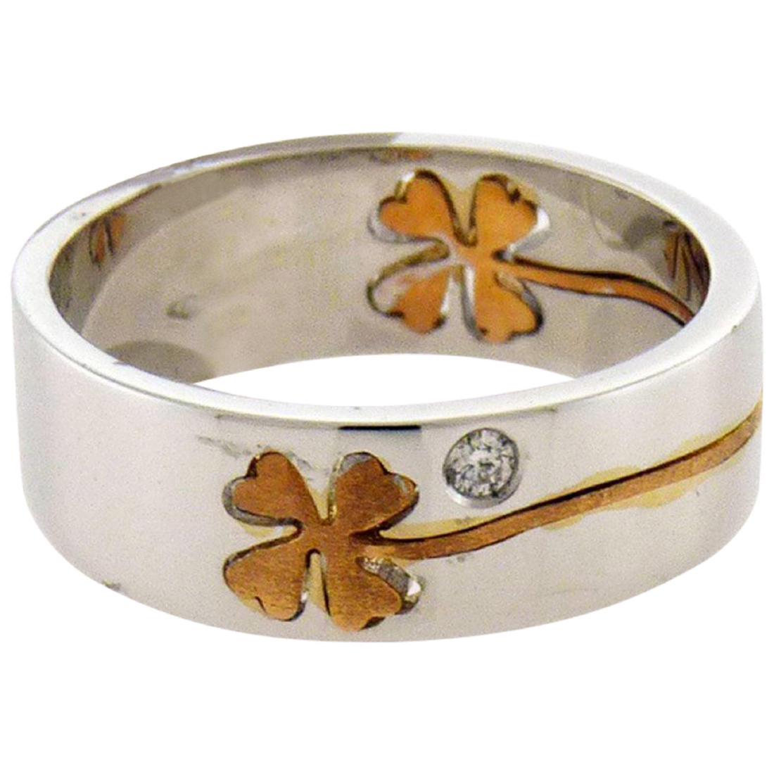 Crivelli 18 Karat Gold Diamond Four-Leaf Clover Ring: Crivelli 18K gold diamond ring with a four-leaf clover mounted, accented with two diamonds. Retail price: $2,970 Diamonds: 0.06 carat Size: 8.5 Weight: 9.8 grams Details Creator Crivelli Place of Orig