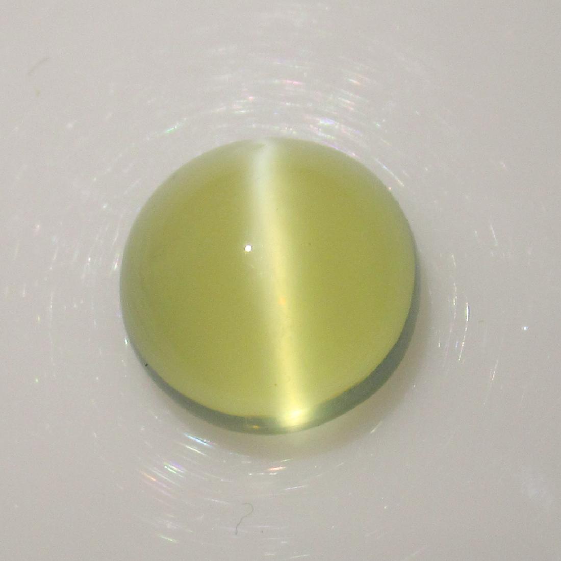 7.38 Ct Genuine Moonstone Catseye 12 mm Round Cab: No Reserve! Title: 7.38 Ct Genuine Moonstone Catseye 12 mm Round Cab Stone Clarity: Transparent Gemstones: Natural Moonstone Catseye Carat Weights: 7.38 Size/Dimensions: 11.90 x 11.90 x 7.30 mm Additi