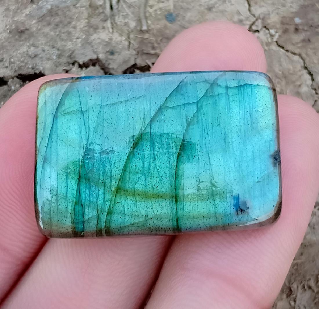 44.10 Carat Natural Labradorite Cab: Title: 44.10 Carat Natural Labradorite Cab Color/Clarity: None Gemstones: Labradorite Carat Weights: 44.10 Carat Size/Dimensions: 31x21x6 mm Origin: Madagascar Treatment: Natural Reserve: $20.00 Shi