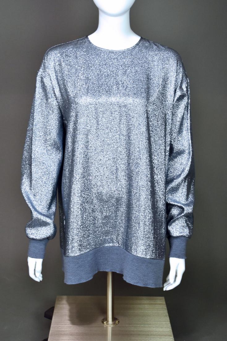 Stella McCartney Baby Blue Lurex Pullover Top: Stunning baby blue blouse from Stella McCartney is silk with polyester lurex woven throughout. The knitted cuffs and bottom band are soft wool rib knit. This is a pullover style blouse with a single b