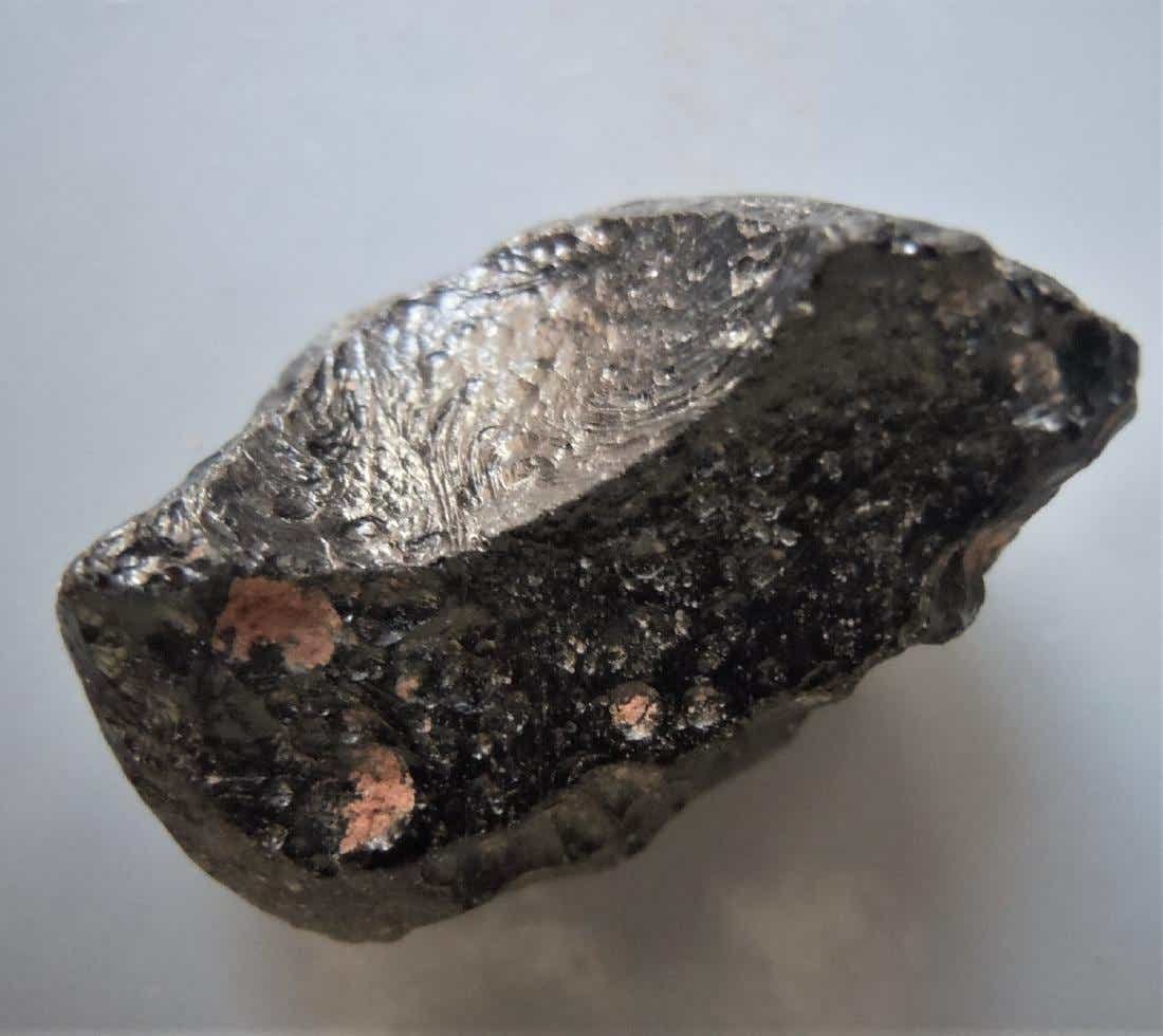 THAILANDITE TEKTITE - FROM METEORITE IMPACT: Title: THAILANDITE TEKTITE - FROM METEORITE IMPACT Origin: Noen Sa-nga, Chaiyaphum Prov. Thailand Size: 2.5x1.5x1.45 cm / 5 gram crescent shaped thailandite tektite. smooth and pitted sides. minor sed