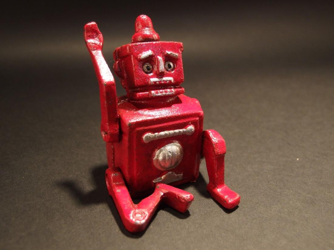 Style Mini Cast Iron Red Robert the Robot Toy: 2 L x 2.5 W x 3.5 H Great little reproduction cast iron robot. All cast iron hand painted, slightly distress as shown in the images. Certainly looks old! This looks alot like the mechanical coin bank 