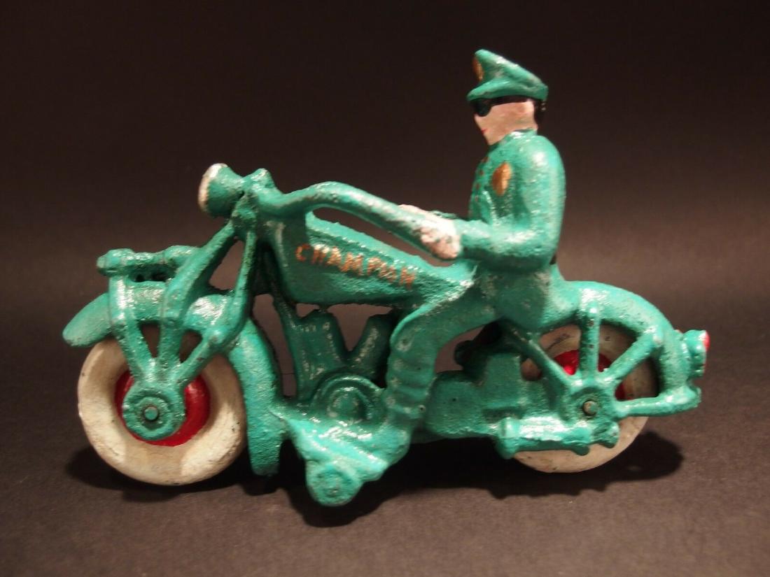 Green Cast Iron Toy Motorcycle Police Rider Cop: 7" Long x 2 1/4" Wide 3 3/4" Tall 2 lbs 5 oz Such a neat reproduction cast iron motorcycle! As you can see this heavy cast iron pull toy motorcycle was wonderfully hand painted and distressed to look 