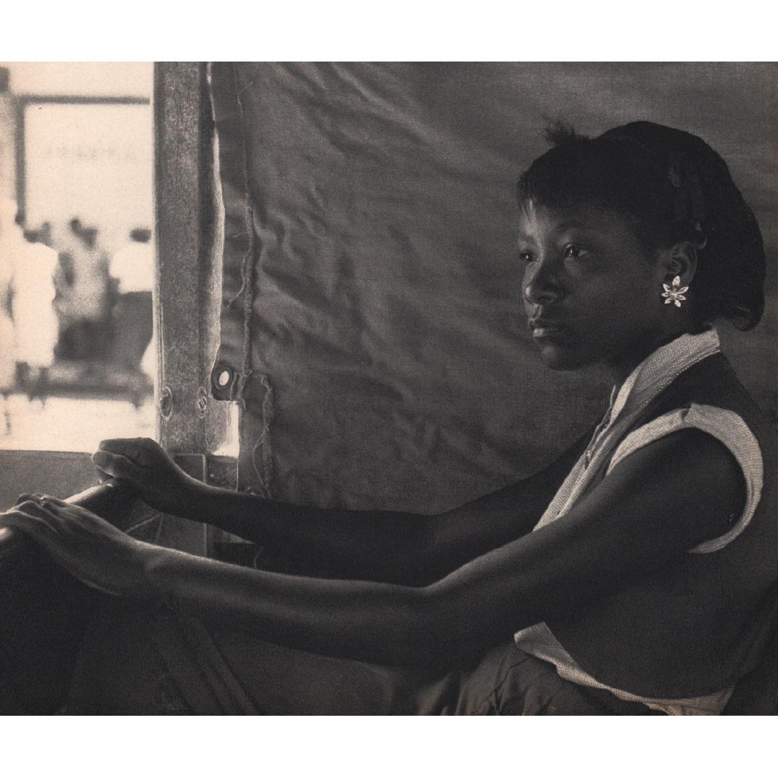 HERBERT LIST - In the Bus, Martinique: Artist: HERBERT LIST Print Title: In the Bus, Martinique Medium: Sheet-fed Gravure Printing Date: 1950's Printed in Switzerland Image Size approx: 9 x 7.5 inches Herbert List (1903-1973) was a German
