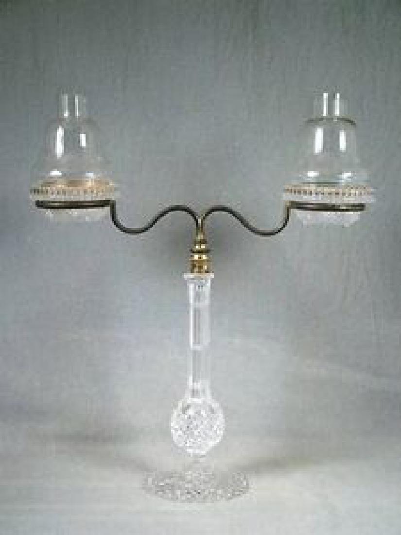 Clear Cricklite double fairy lamp on cut-glass standard: Title: Clear Cricklite double fairy lamp on cut-glass standard Description: Clear Cricklite double fairy lamp on cut-glass standard DATE Victorian, circa 1900 DESCRIPTION Two clear glass ogee domes wi