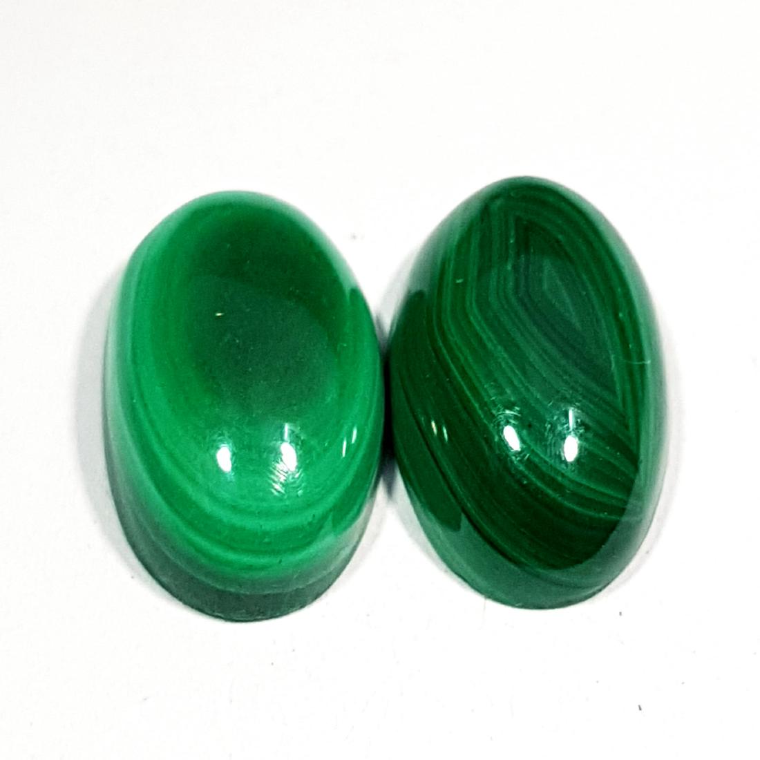 2 Pcs of Natural Malachite Oval Cut - 23.25 ct: No Reserve! Title: 2 Pcs of Natural Malachite Oval Cut - 23.25 ct Color/Clarity: Opaque Gemstones: Gemstones Carat Weights: $23 Size/Dimensions: 17.80 x 10.50 x 5.65/17.40 x 10.40 x 5.70 Additional In