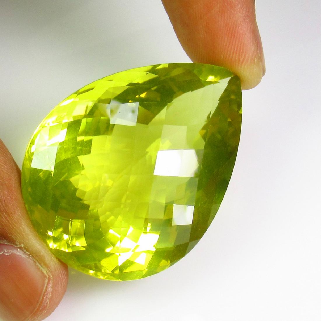 115.32 Ct Genuine Lemon Quartz 41X30 mm Pear Cut: Title: 115.32 Ct Genuine Lemon Quartz 41X30 mm Pear Cut BigSize Stone Clarity: VVS Gemstones: Natural Lemon Quartz Carat Weights: 115.32 Size/Dimensions: 41.00 x 30.00 x 18.50 mm Additional Informatio