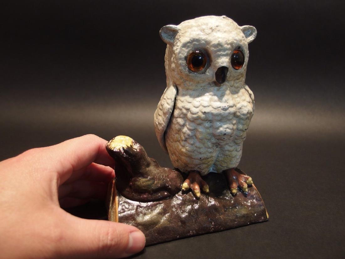 Cast Iron Owl on Log Coin Bank Door Stop: 6 1/2" Tall x 5" long x 3 3/4" Wide 3 lbs 12oz A wonderful reproduction cast iron white owl on a log coin bank. This owl bank as you can see has a seam down the middle. It is somewhat hollow yet still