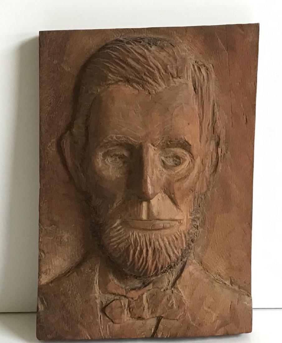 Lincoln Carving: Title: Lincoln Carving Date/Period: Early 20thc Dimension: 10” x 7” Provenance:Folksy carving of Abe Lincoln done on hardwood; sticker with #43 on reverse is a collection # Shipping: Domestic: Fla