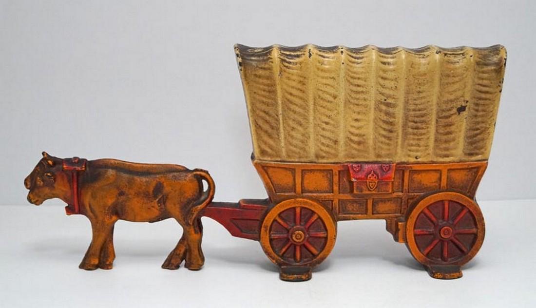Conestoga Wagon w/ Team of Oxen Cast Iron Doorstop: Title: Conestoga Wagon w/ Team of Oxen Cast Iron Doorstop Date/Period: Circa 1920's. Dimension: 6 7/8" tall x 14 1/8" long x 3" wide. Provenance:An Antique RARE & DESIRABLE Conestoga Wagon with Team o