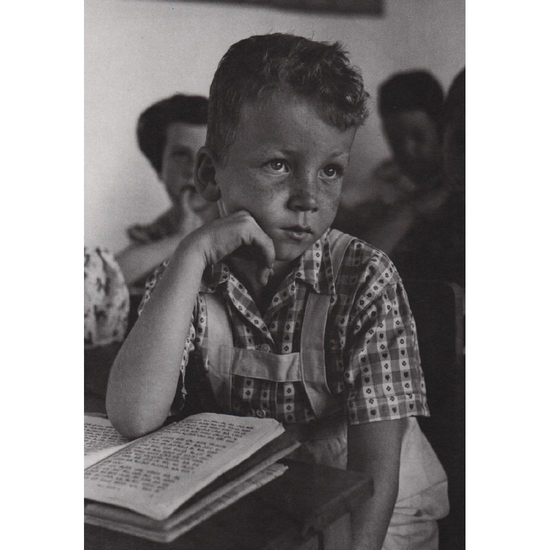 RUTH ORKIN - Student in his Israeli Classroom: Artist: RUTH ORKIN Print Title: Student in his Israeli Classroom Medium: Sheet-fed Gravure Printing Date: 1980's Printed in the USA Image Size approx: 6.25 X 9 inches Ruth Orkin (1921-1985) was an Ame
