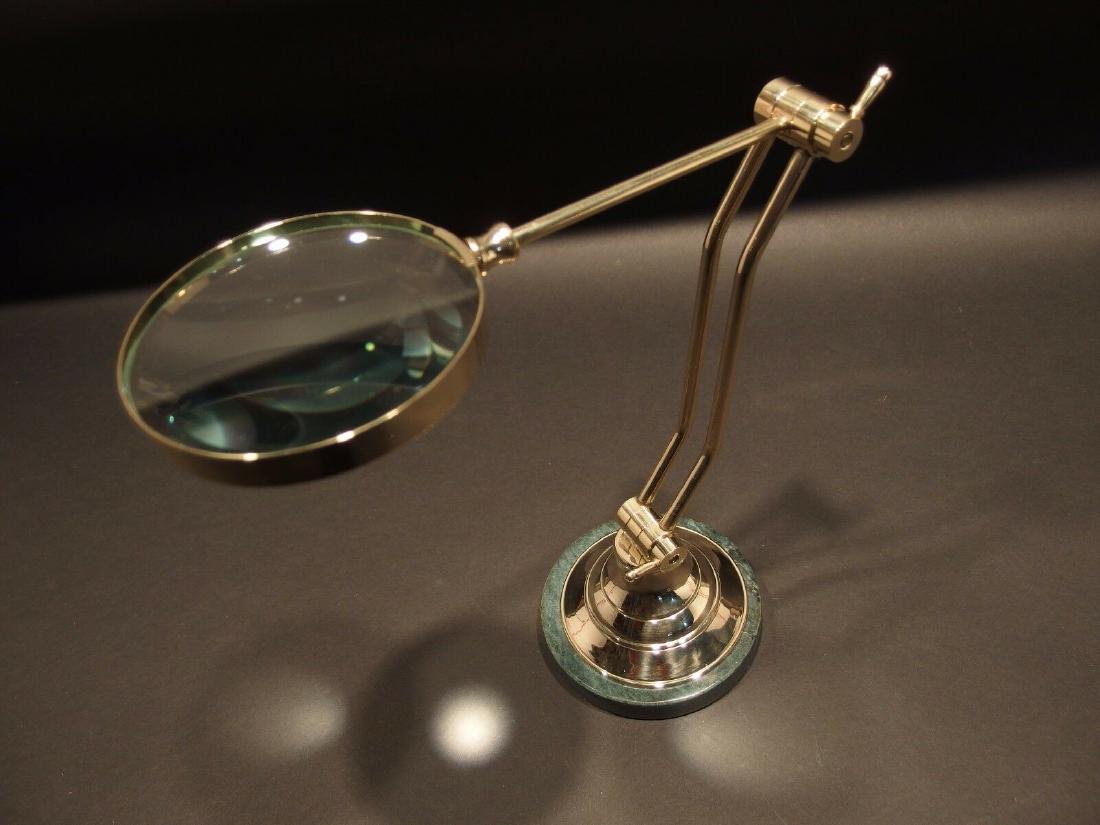 Adjustable Table top Arm Magnifying glass: 12" Tall 9 5/8" long arm.. Nice reproduction of an antique! All solid brass and heavy marble looking base. The arm adjust is quite stiff. It will tip over if the adjustment is made too far off balance