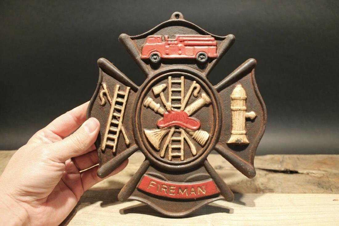 Cast Iron Fire Fighter Plaque Fire Mark Sign: 9" Tall x 7 3/4" Wide Well made reproduction cast iron Fire Fighter Fireman plaque. Be sure to see the pictures.. looks old but is actually fairly new.. Reserve: $30.00 Shipping: Domestic: Flat-rate o