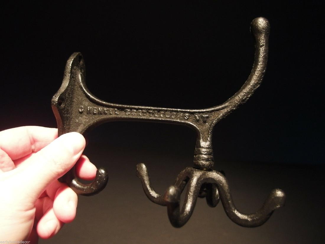 BLACK Cast Iron Hook Rotating Bracket Spinning Coat: (1) Hook 6" Tall.. 4 1/4" Wide 6" Extension 1 Charming and functional sturdy iron wall hook cast from an antique. Notice the 4 fully rotating bottom hooks. All Heavy cast iron.... Cast hook reads: Hen