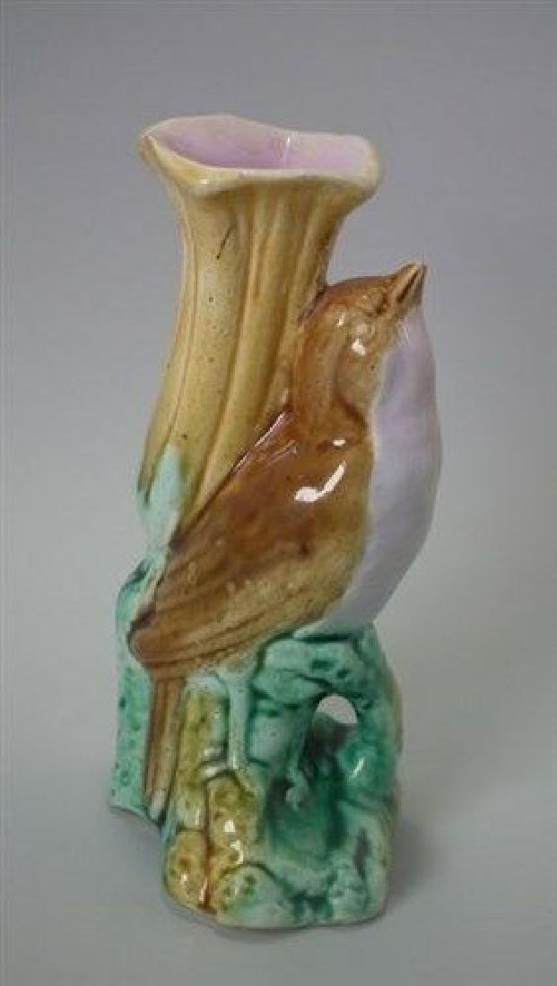 Majolica bird posy vase: Title: Majolica bird posy vase Description: Majolica bird posy vase Description Majolica posy holder which features a bird perched on a rocky mound in front of a trumpet-shaped flower. Colouration: br
