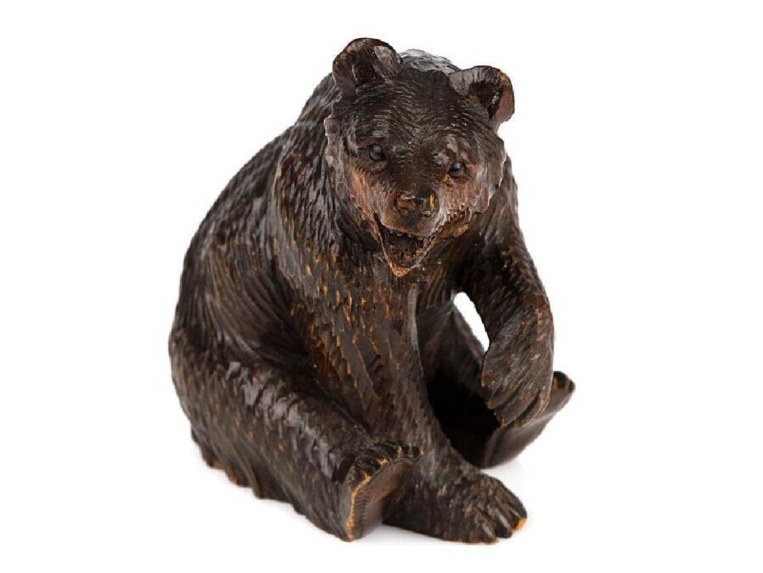 c1905 Black Forest Carved Wooden Seated Bear Ornament: c1905 Black Forest Carved Wooden Seated Bear Ornament A beautiful, finely carved wooden Black Forest ornament, in the shape of a very naturalistic seated Brown Bear with glass bead eyes. Condition is 