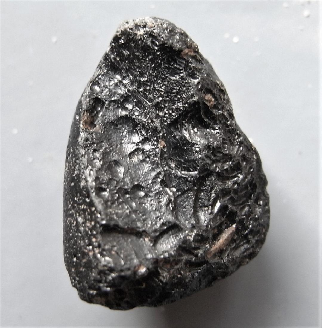 THAILANDITE TEKTITE - FROM METEORITE IMPACT: Title: THAILANDITE TEKTITE - FROM METEORITE IMPACT Origin: Noen Sa-Nga, Chaiyaphum Prov. Thailand Size: 2.25x1.6x1.15 cm / 4 gram Description: irregular shaped thailandite tektite with reticulate surf