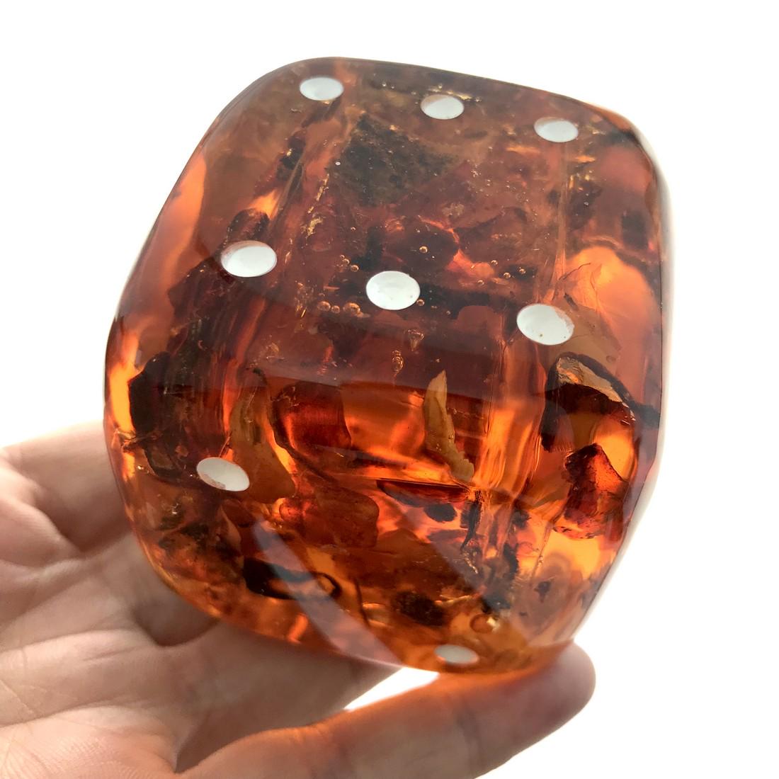 Large Amber cube game dice d6: Title: Large Amber cube game dice d6 Gemstone: Amber Weight: 203 gr Size: 56 mm Additional Information: Baltic amber stones inclusions into the translucent polymeric resin. Amber heals and supports th