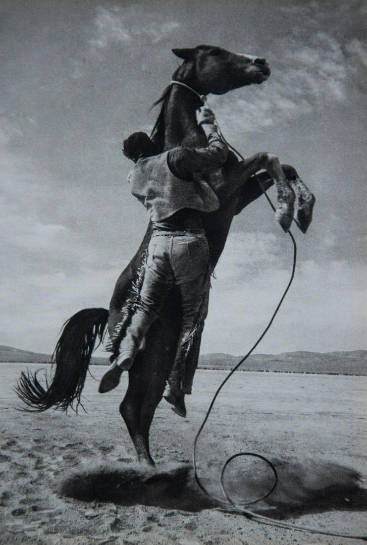 ERNST HAAS - Breaking In A Mustang 1960: Artist: Ernst Haas Title: Breaking In A Mustang 1960 Medium: Sheet Fed Gravure, 1972, France Dimensions: 6.1x8.85" Heat Wax Mounted on 11x14" Conservation Board Ernst Haas (1921-1986) was a photojourn