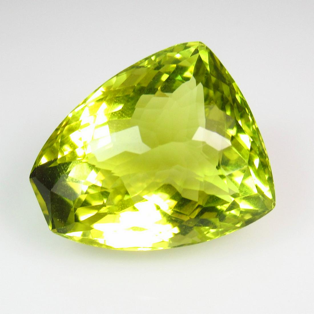 27.92 Ct Genuine Yellow Lemon Quartz Fancy Cut: Title: 27.92 Ct Genuine Yellow Lemon Quartz Fancy Cut Stone Clarity: VVS Loose Gemstone: Natural Lemon Quartz Carat Weights: 27.92 Size / Dimensions: 21.00 x 17.80 x 13.60 mm Good Luster / Top Class Q