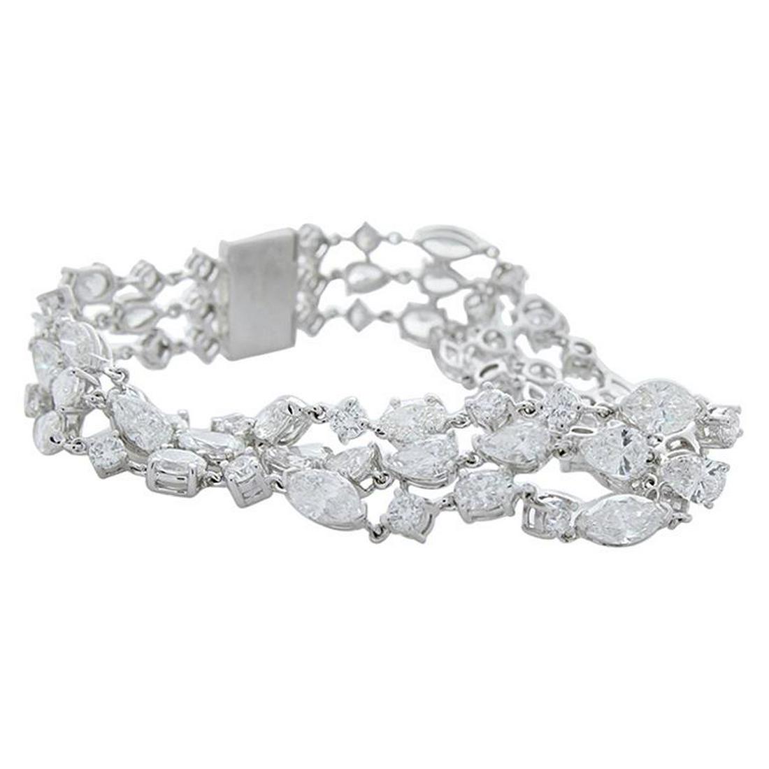 21.05 Carat Total Weight 3 Rows of Fancy Shaped Diamond: Pears, ovals, marquises, and round diamonds come together in pitch perfect harmony to create this spectacular diamond bracelet. Magnificently handcrafted in 18 karat white gold, this piece boasts a co